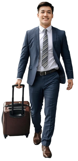 Business traveler walking through the terminal with his luggage