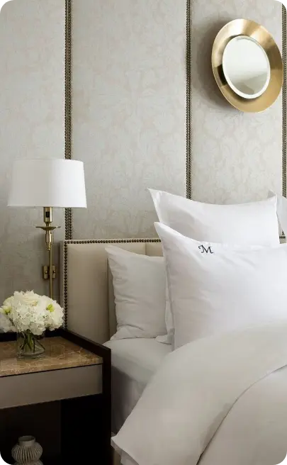 Made-up hotel bed with fresh flowers